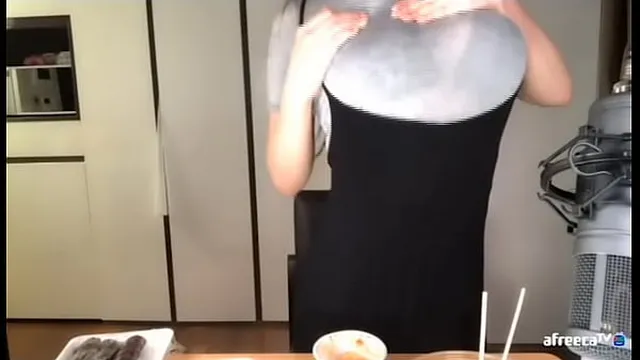 Korean babe fondling her boobs through clothes